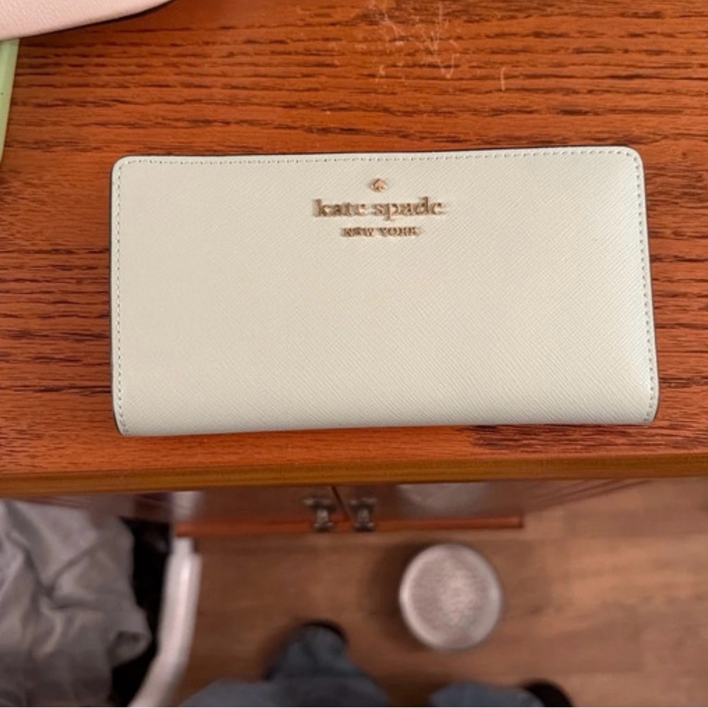 kate spade light green saffiano zip-around wallet with gold logo